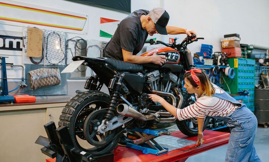 mechanic working on a motorcycle lifted using motorcycle lift