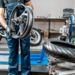 worker changing a motorcycle tire