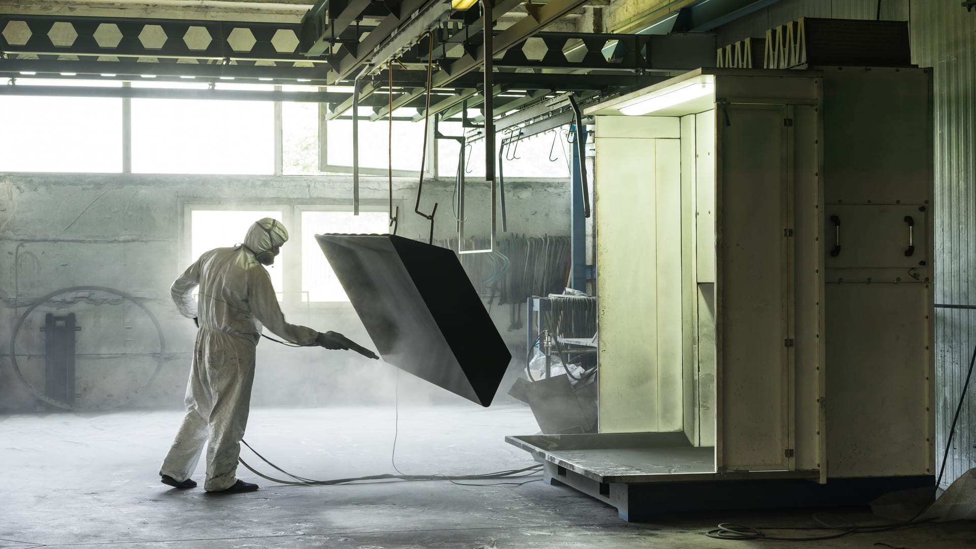 sand blasting a metal crate