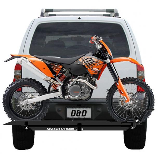 a motorcycle on the back of a car using a hitch carrier